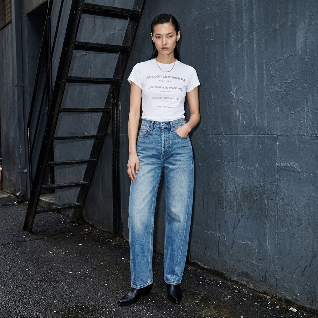 Alexander Wang Float Jeans in washed mid-blue denim with a high rise and curved twisted-seam leg, shown from the front - lifestyle