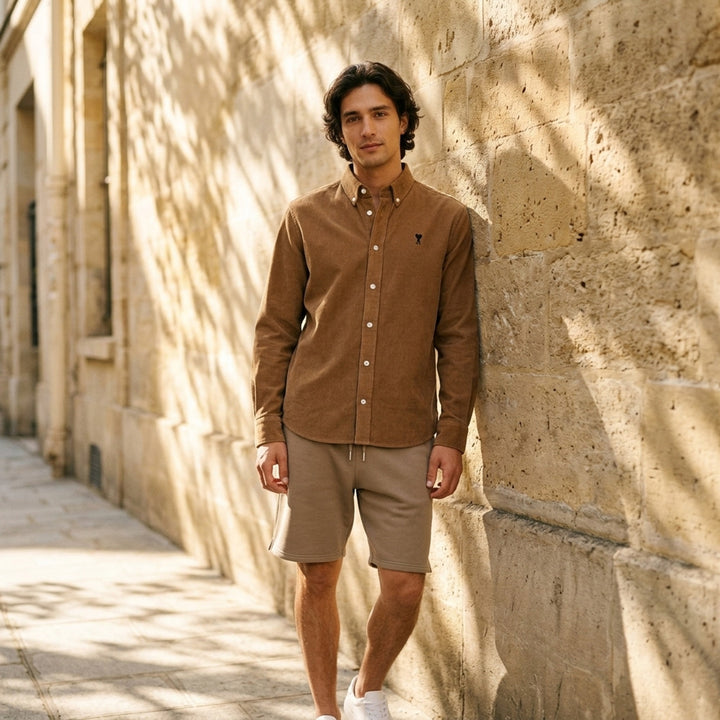 AMI Alexandre Mattiussi fine-wale corduroy button-down shirt in camel with embroidered Ami de Cœur logo at the chest and button-down collar - lifestyle