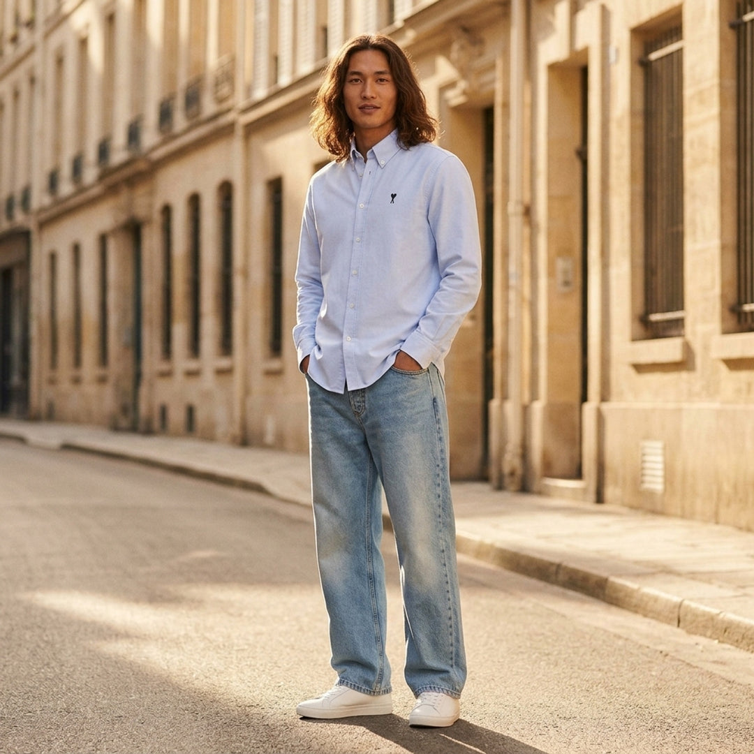 AMI Large Fit Jeans in light blue stonewash denim, featuring a relaxed wide-leg silhouette, five-pocket construction, and contrast copper topstitching - lifestyle