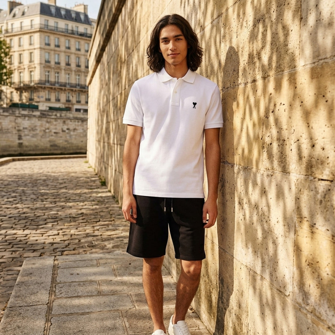 Ami Alexandre Mattiussi black piqué polo shirt with white Ami de Cœur logo embroidery on the chest and a two-button placket, front view - lifestyle