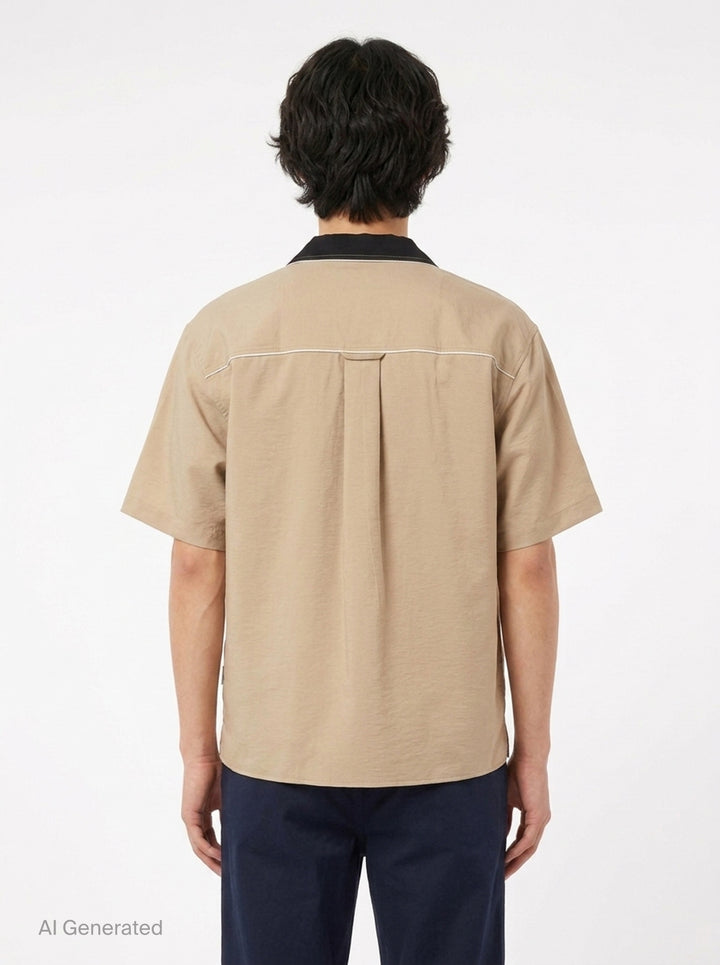AMI Alexandre Mattiussi Shark Collar Boxy Short Sleeve Shirt in tan and black with contrast cream piping and button-through front, flat lay on white background - back