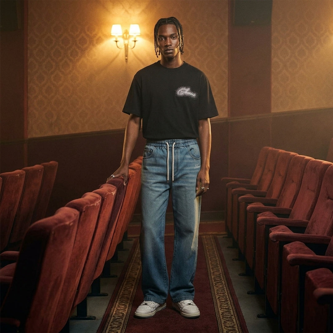 Amiri baggy drawstring jeans in washed light-blue denim with an elasticated waist, white rope drawcord and embroidered script logo at the hip - lifestyle