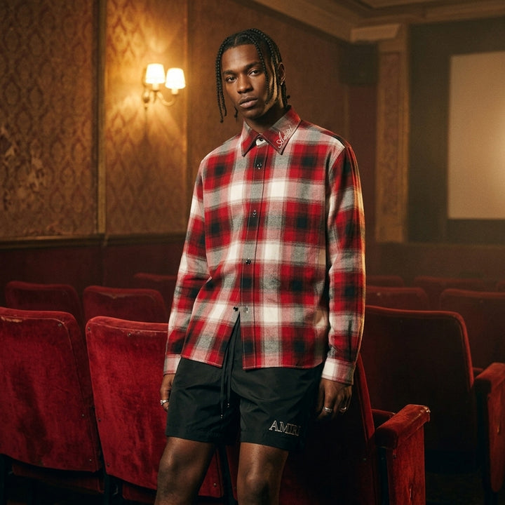 Amiri oversized flannel shirt in red, black and cream ombré plaid with embroidered script logo on the collar and black buttons - lifestyle