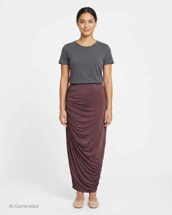 Balmain draped jersey midi skirt in deep burgundy with asymmetric waist, ruched side detail, front slit and gold-tone tassel - front