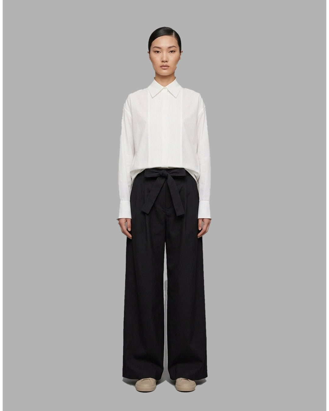 Khaki wide-leg pleated pants with a high-rise waist and self-tie bow belt, shown flat against a white background - front