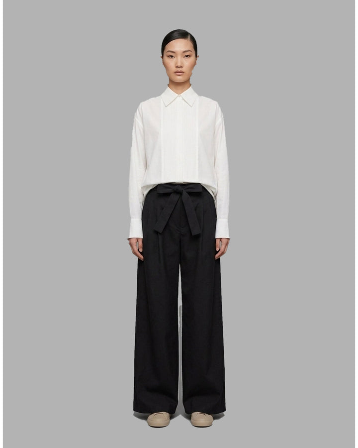Khaki wide-leg pleated pants with a high-rise waist and self-tie bow belt, shown flat against a white background - front