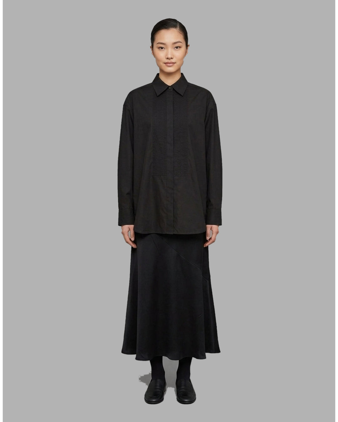Ivory matte acetate-mix maxi skirt with a diagonal seam and flared hem, shown from the front - front