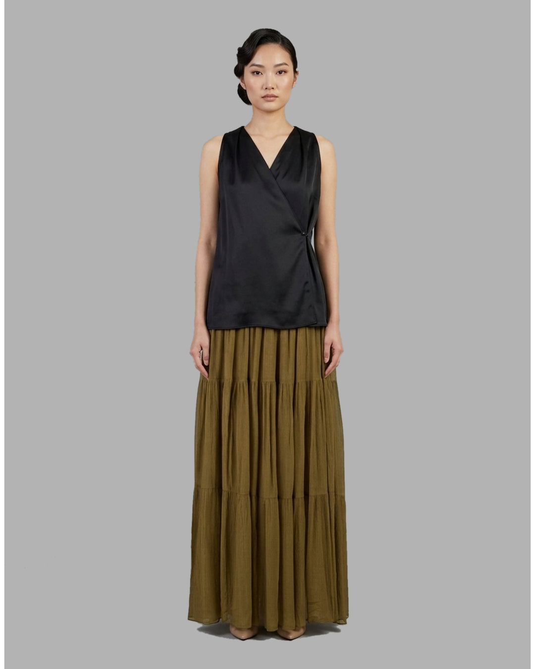 Black tiered maxi skirt in crinkled silk-blend chiffon with a smocked high waist and flowing semi-sheer layers - front