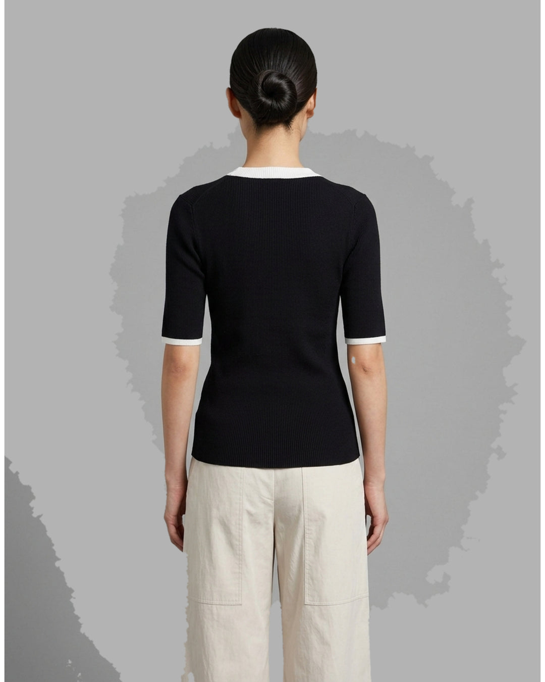 Ivory ribbed silk-cotton knit top with black contrast trim at the scoop neckline and short sleeve cuffs, by Club21 Collection - back