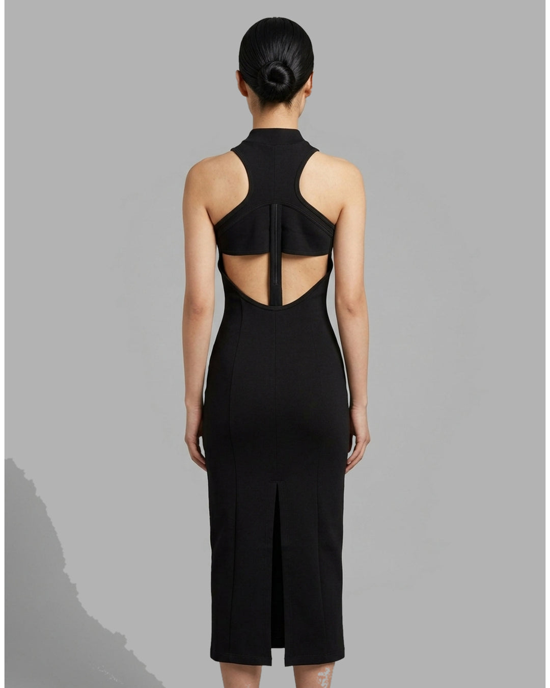 Back view of the Luna sleeveless high-neck midi dress in black stretch modal jersey with a concealed centre back zip - back