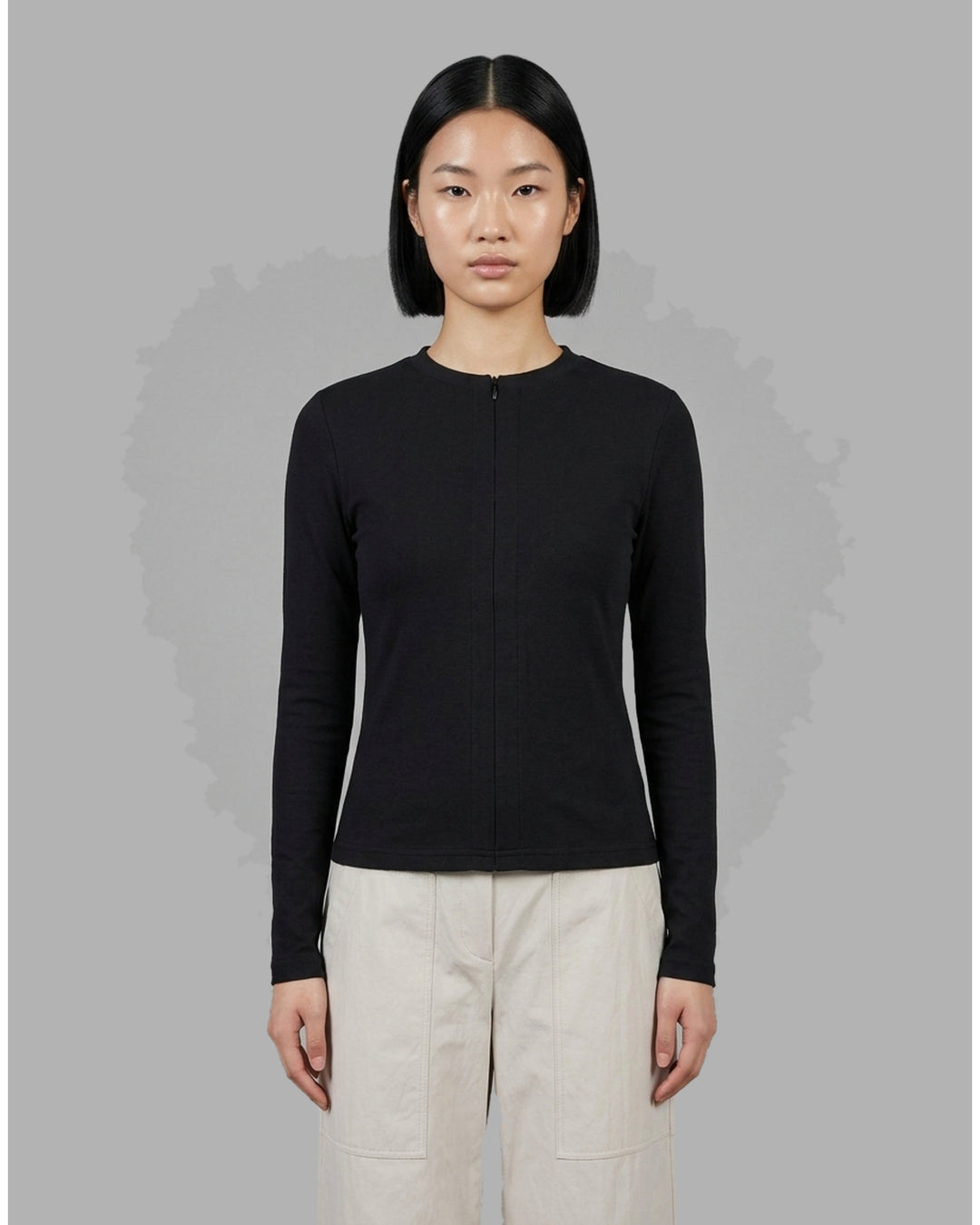 Black long sleeve zip-front top in high stretch modal jersey with a crew neckline and vertical front seams - front