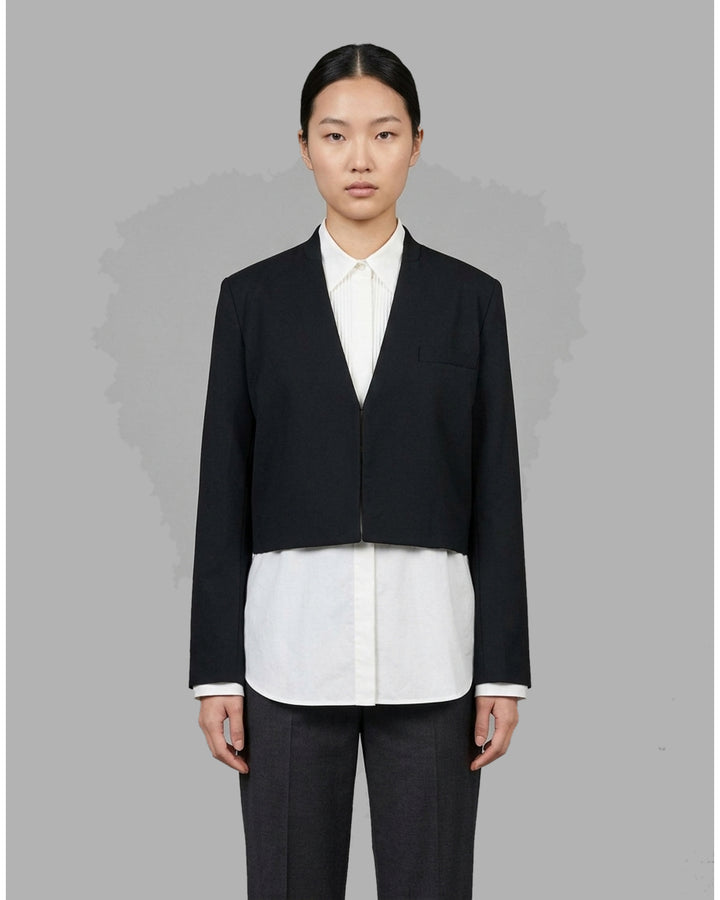 Black collarless cropped jacket with asymmetric wrap front and chest flap detail by Club21 Collection - front