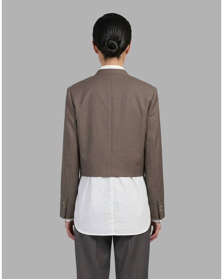 Black collarless cropped jacket with asymmetric wrap front and chest flap detail by Club21 Collection - back