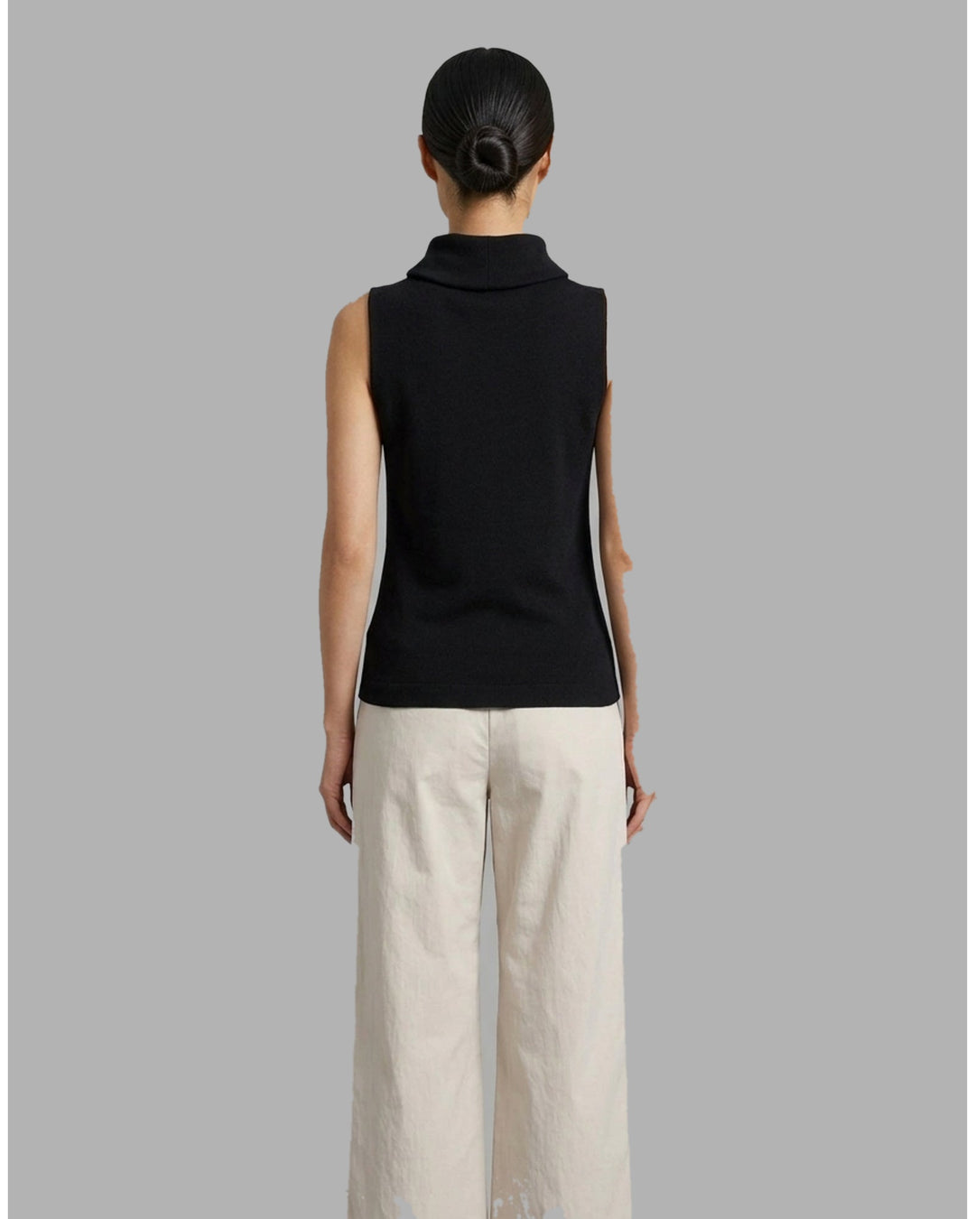 Black sleeveless roll neck knit top in fine ribbed silk cotton yarn, shown flat from the front - back