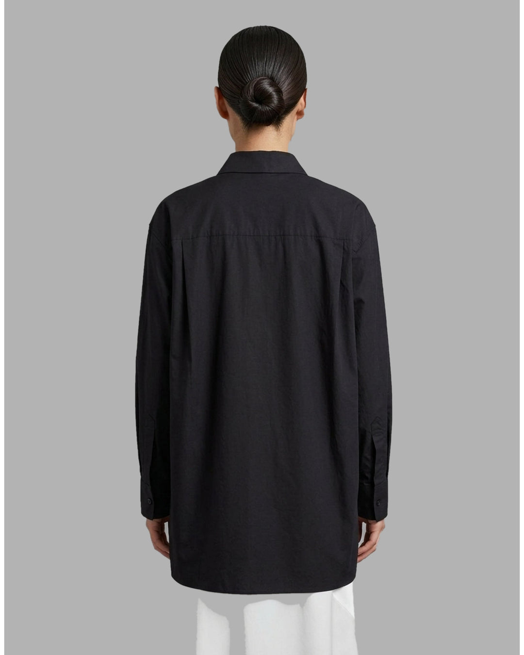 Black cotton tuxedo-style shirt with pleated bib front, concealed button placket and pointed collar from Club21 Collection - back
