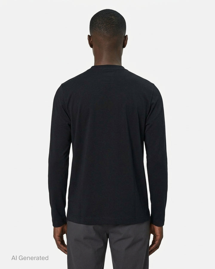Comme des Garçons Homme Plus black long-sleeve polyester jersey tee with sculptural curved overlay bib panel and open split hem, displayed flat on white background - back