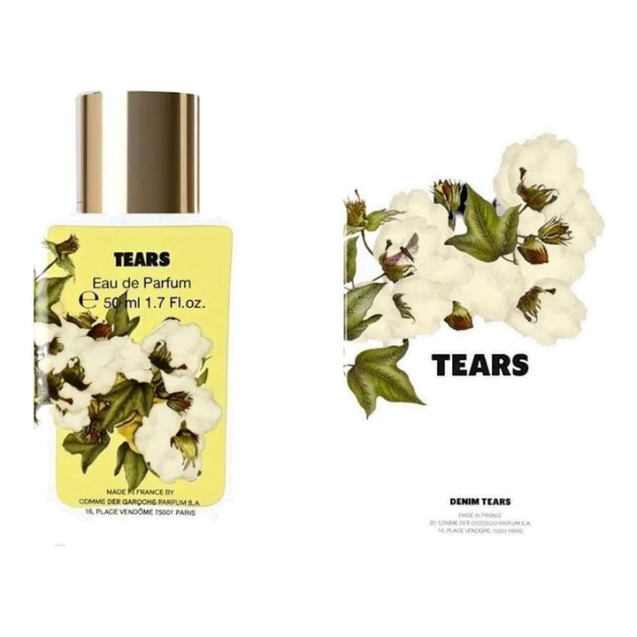 Tears Eau de Parfum 50ml by Comme des Garçons Parfums in a white glass bottle with a gold cap and yellow cotton blossom label - packshot