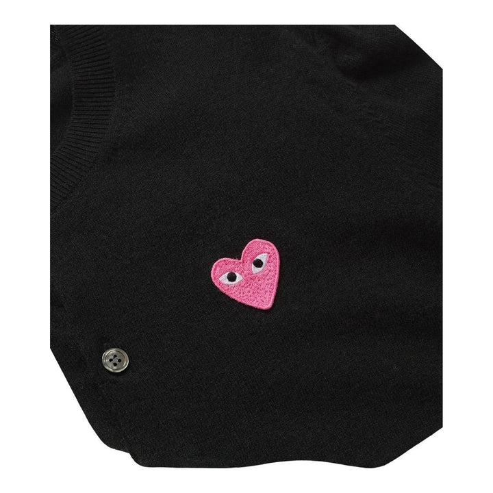 Comme des Garçons PLAY black round neck cardigan with embroidered pink heart emblem patch and button-through front fastening, flat lay view - packshot