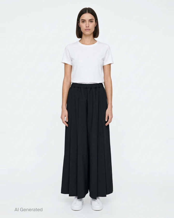 Comme des Garçons black pleated wide-leg trousers with elasticated waistband and fluid, midi-length silhouette, displayed flat on a white background - front
