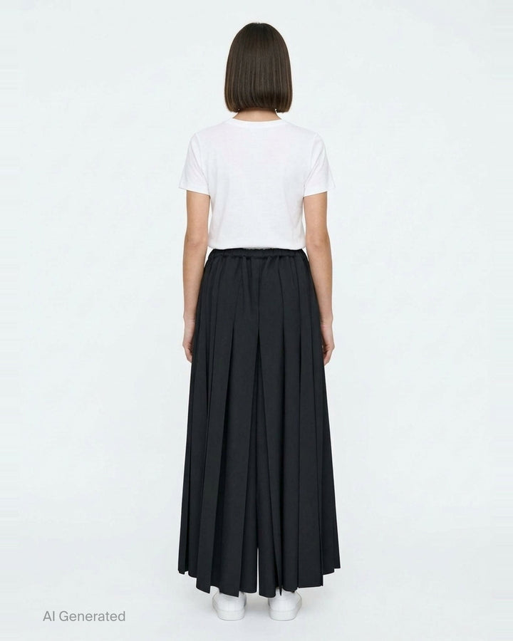Comme des Garçons black pleated wide-leg trousers with elasticated waistband and fluid, midi-length silhouette, displayed flat on a white background - back