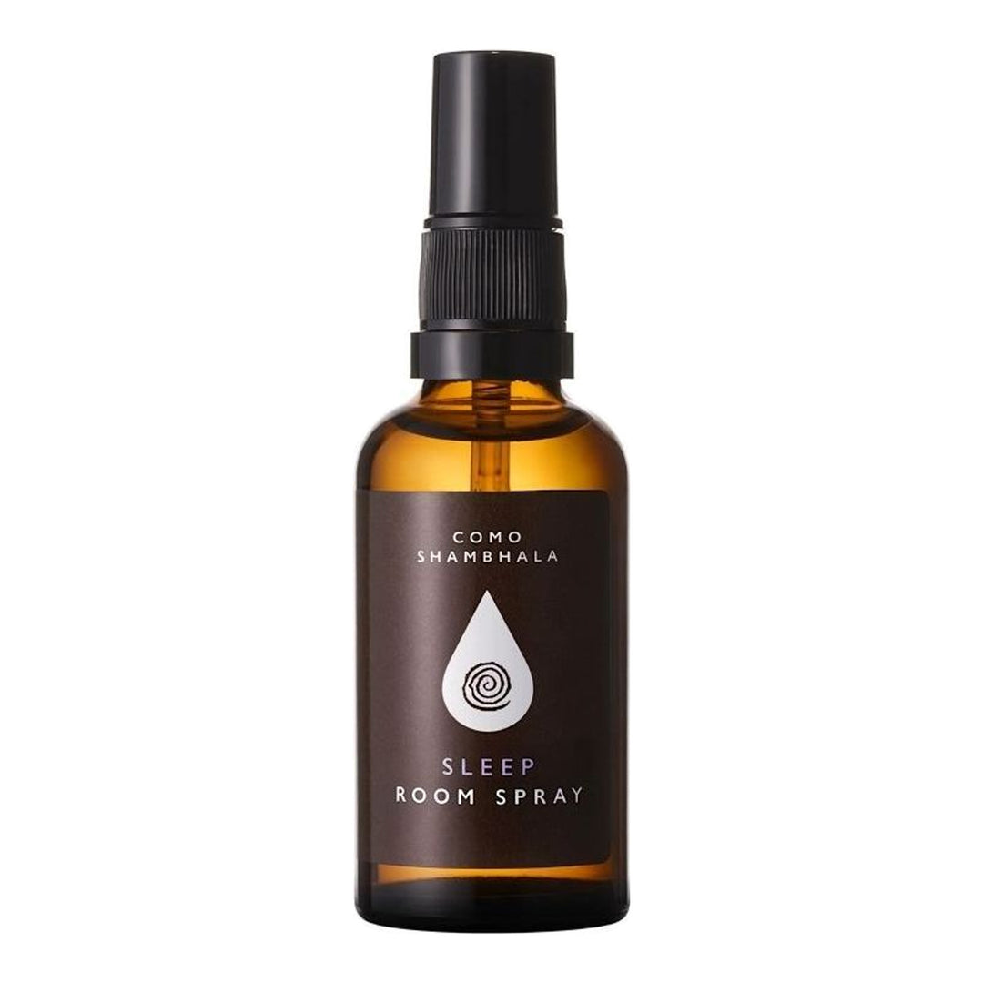 COMO Shambhala Invigorate Room Spray in an amber glass bottle with black spray pump and brown label featuring a white droplet emblem - packshot