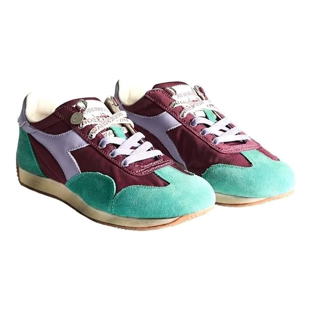 Diadora x JW Anderson retro nylon sneaker in blue with khaki suede overlays, coral laces, and a white Diadora logo stripe, set against a white background - packshot