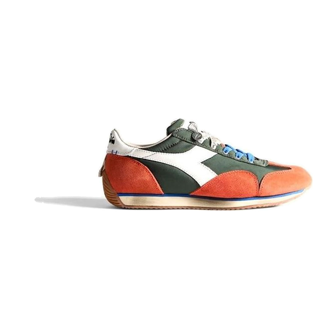 Diadora x JW Anderson retro nylon sneaker in blue with khaki suede overlays, coral laces, and a white Diadora logo stripe, set against a white background - packshot