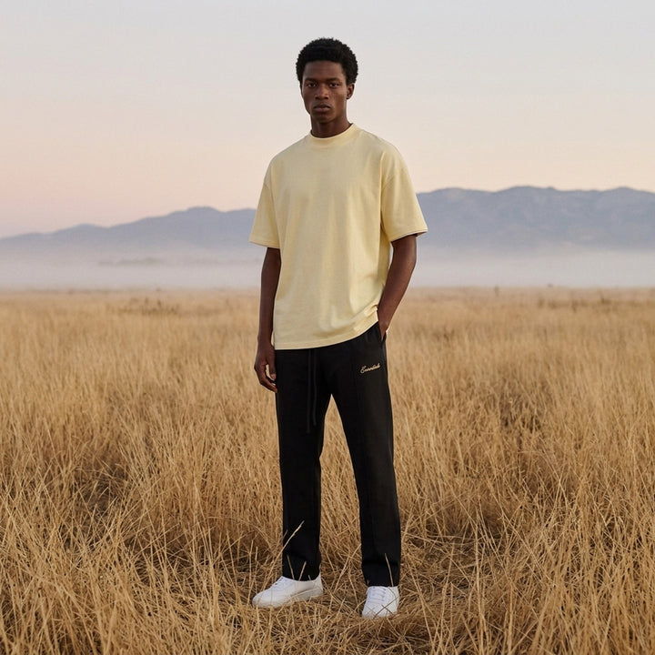 Fear of God ESSENTIALS Classic Double Layer Tee in black with white undertee at the neckline and hem and tonal embroidered logo at the chest - lifestyle