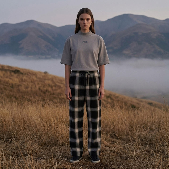 Fear of God ESSENTIALS women's slim mockneck tee in black with ribbed high neck, short sleeves and small white logo at the centre chest - lifestyle