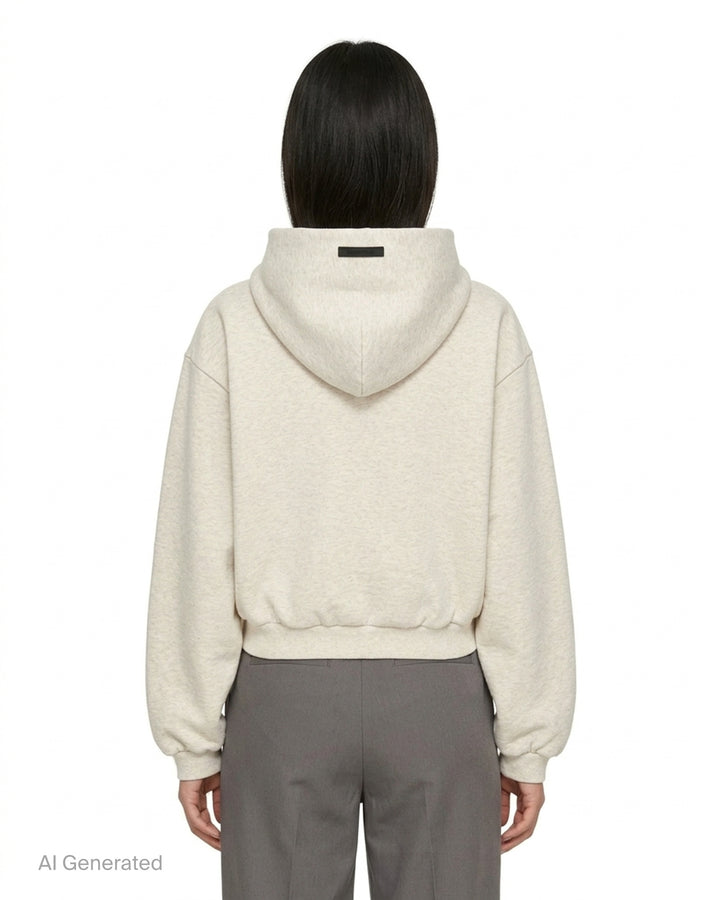 Fear of God Essentials women's modern cropped zip hoodie in washed black with embroidered script Essentials logo on the chest and front hand pockets - back