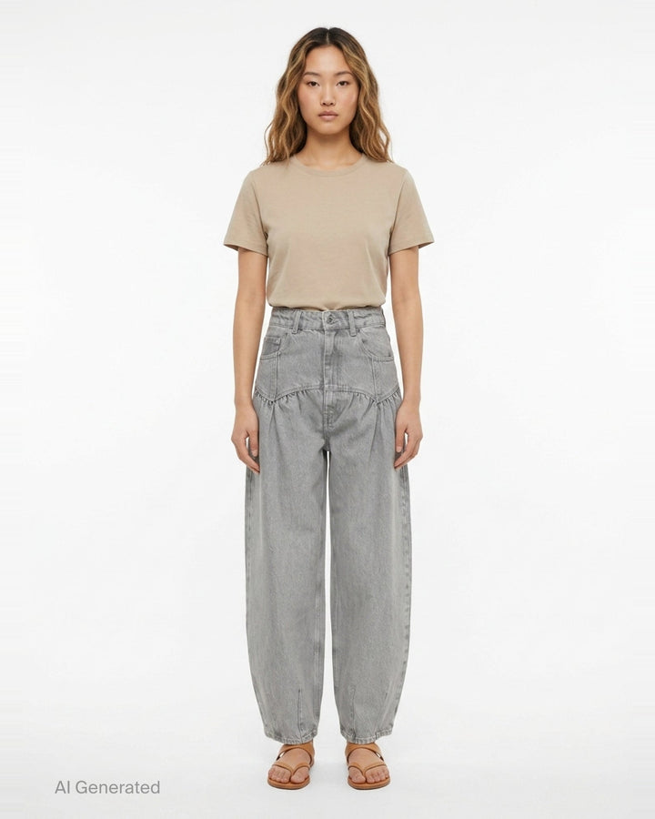 Ganni Rigid Denim Corset Jeans in light grey, featuring a high-rise waist, ruched corset seaming at the hip, and a wide balloon-leg silhouette tapering to small hem vents — front view on white background - front