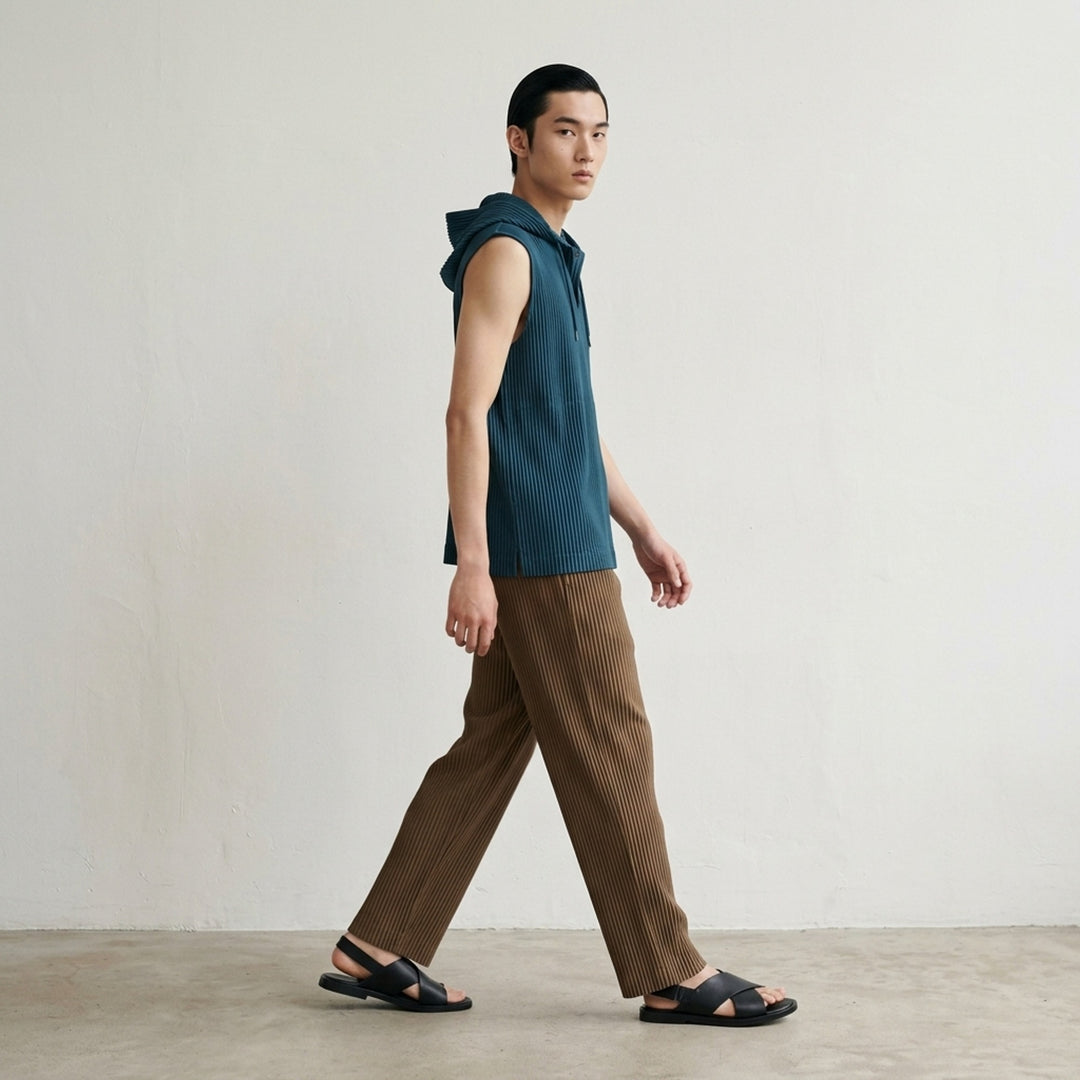 Homme Plissé Issey Miyake Color Pleats 2 pleated pants in teal with signature vertical steam pleats and elastic waistband, straight-leg silhouette, front view - lifestyle