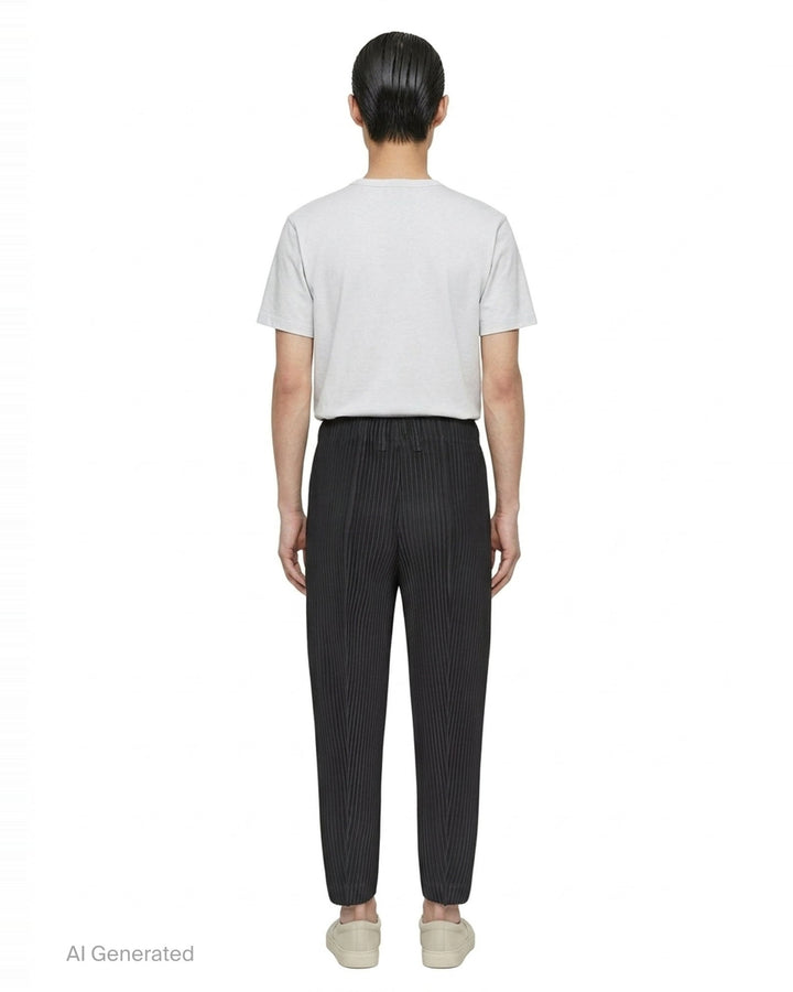 Homme Plissé Issey Miyake Compleat Pleated Trousers in black, shown flat with all-over permanent pleating and elasticated waistband - back
