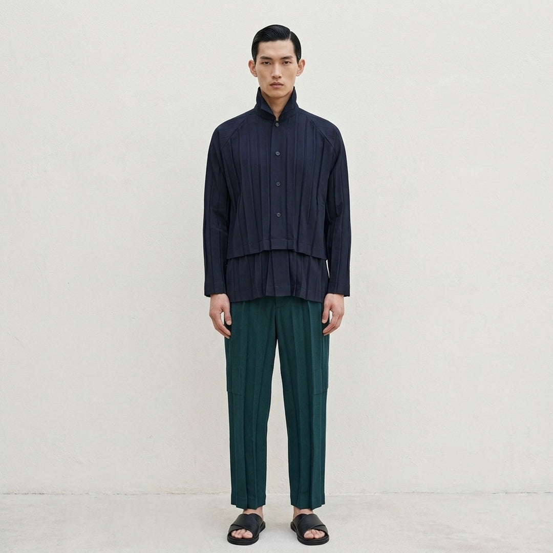 Homme Plissé Issey Miyake Edge Ensemble Pleated Pants in deep teal, featuring wide-leg silhouette with cascading knife pleats and a layered horizontal knee seam, shown flat on white background - lifestyle