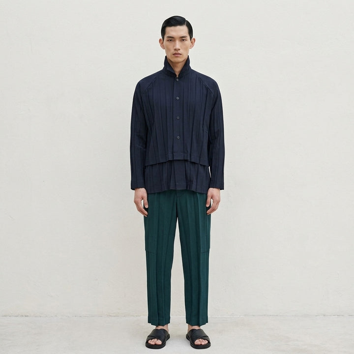 Homme Plissé Issey Miyake Edge Ensemble Pleated Pants in deep teal, featuring wide-leg silhouette with cascading knife pleats and a layered horizontal knee seam, shown flat on white background - lifestyle