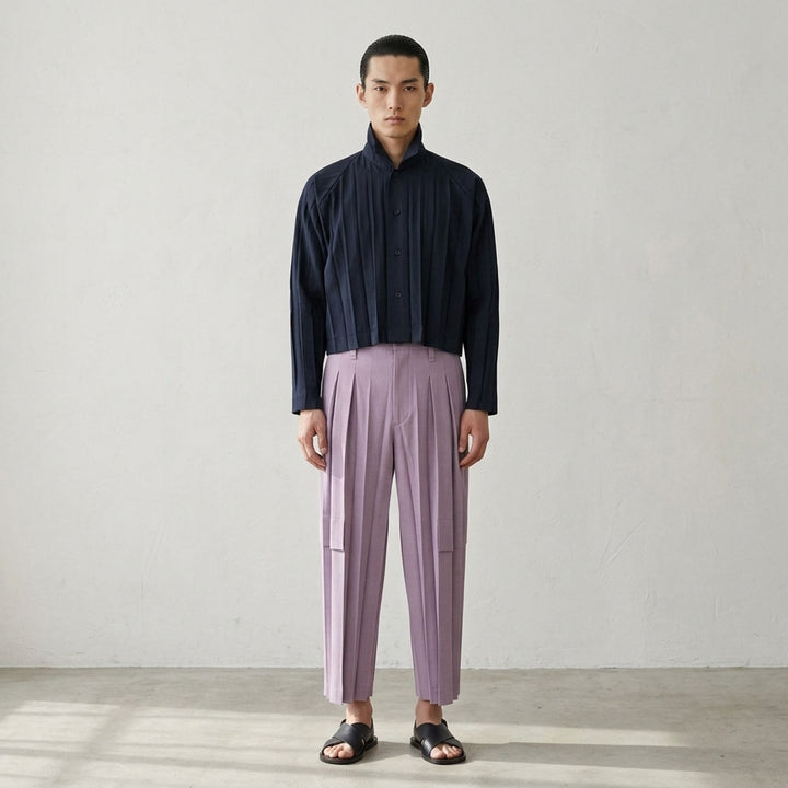 Homme Plissé Issey Miyake Edge Ensemble Pleated Pants in forest teal, featuring deep multi-pleat wide-leg silhouette, high waistband with button fastening, and horizontal panel seam on the lower leg - lifestyle