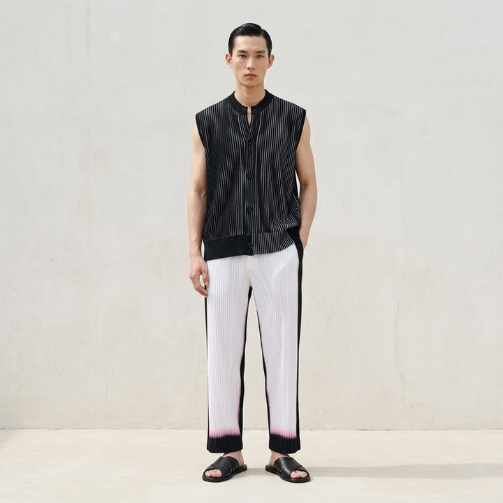 Homme Plissé Issey Miyake Framework : Chusen black pleated pants with a white gradient hem and elasticated waistband, front view - lifestyle