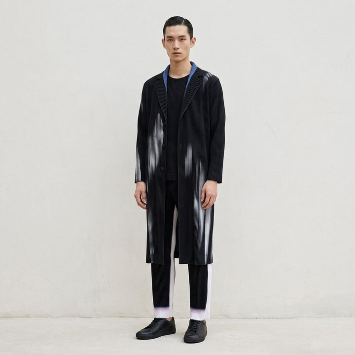 Homme Plissé Issey Miyake In The Shadow long pleated coat in black with blurred pale blue brushstroke print and light blue lining at the collar - lifestyle