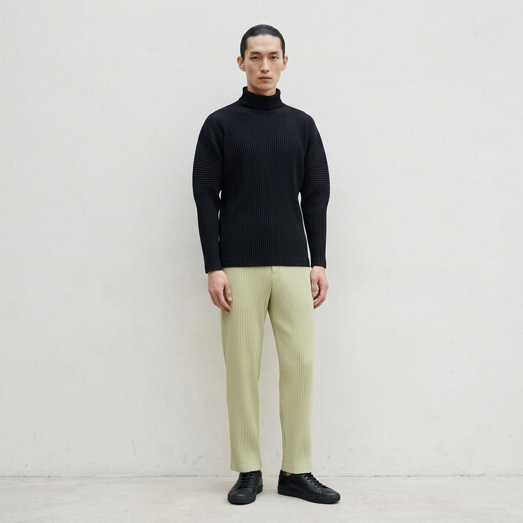Homme Plissé Issey Miyake black micro-pleated long sleeve turtleneck, rear view showing signature accordion-pleat texture across body and sleeves - lifestyle