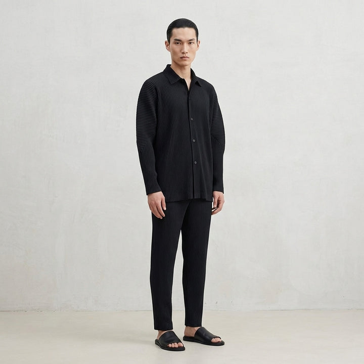 Black long-sleeve pleated button-up shirt by Homme Plissé Issey Miyake from the Monthly Colors October collection, shown from the front - lifestyle