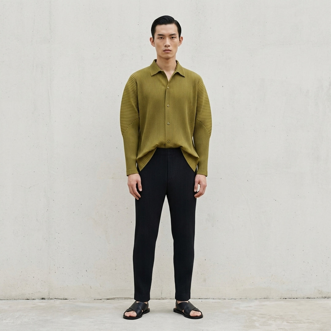 Black long-sleeve pleated button-up shirt by Homme Plissé Issey Miyake from the Monthly Colors October collection, shown from the front - lifestyle