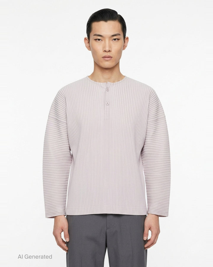 Homme Plissé Issey Miyake Monthly Colors September long-sleeve pleated top in black, featuring all-over accordion pleating and a tonal Henley button neckline - front