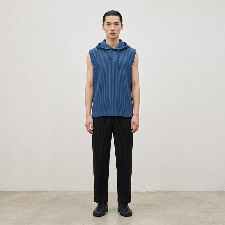 Homme Plissé Issey Miyake Monthly Colors September sleeveless pleated hoodie top in deep ocean blue with drawstring hood and snap-button closure - lifestyle