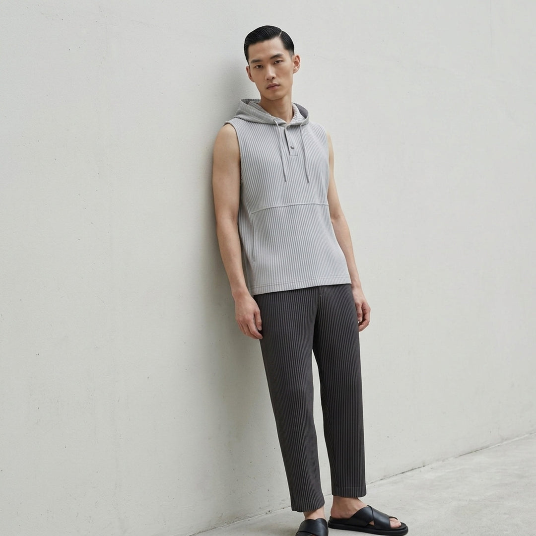Homme Plissé Issey Miyake Monthly Colors September sleeveless pleated hoodie top in deep ocean blue with drawstring hood and snap-button closure - lifestyle