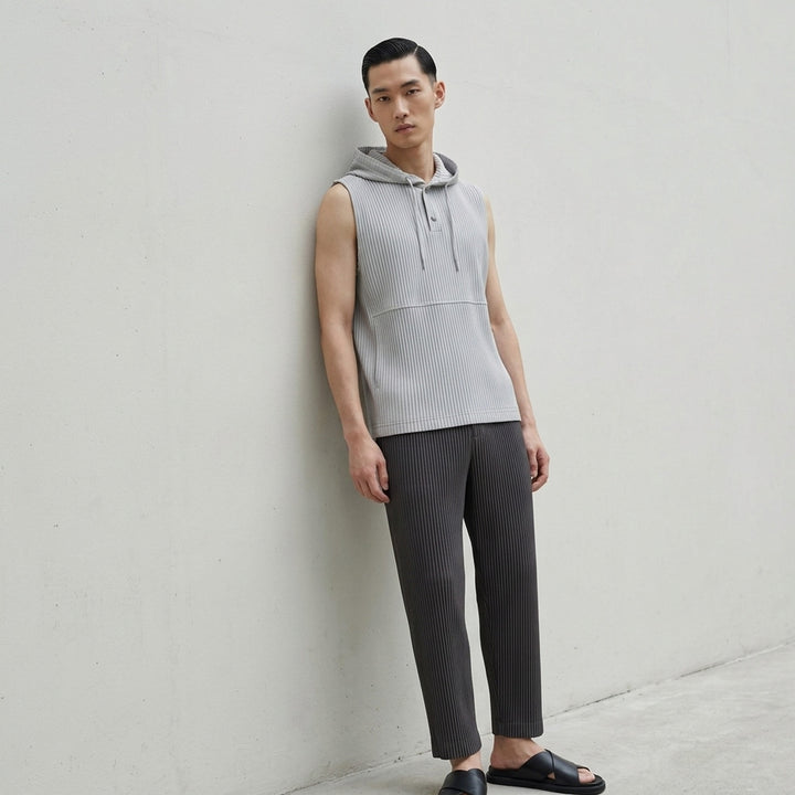 Homme Plissé Issey Miyake Monthly Colors September sleeveless pleated hoodie top in deep ocean blue with drawstring hood and snap-button closure - lifestyle