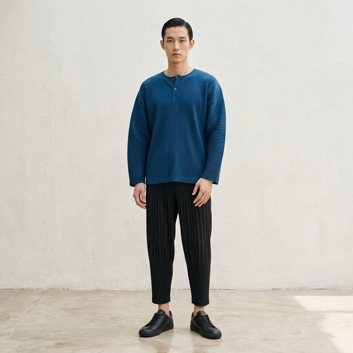 Homme Plissé Issey Miyake Monthly Colors September long-sleeve pleated top in black, featuring all-over accordion pleating and a tonal Henley button neckline - lifestyle