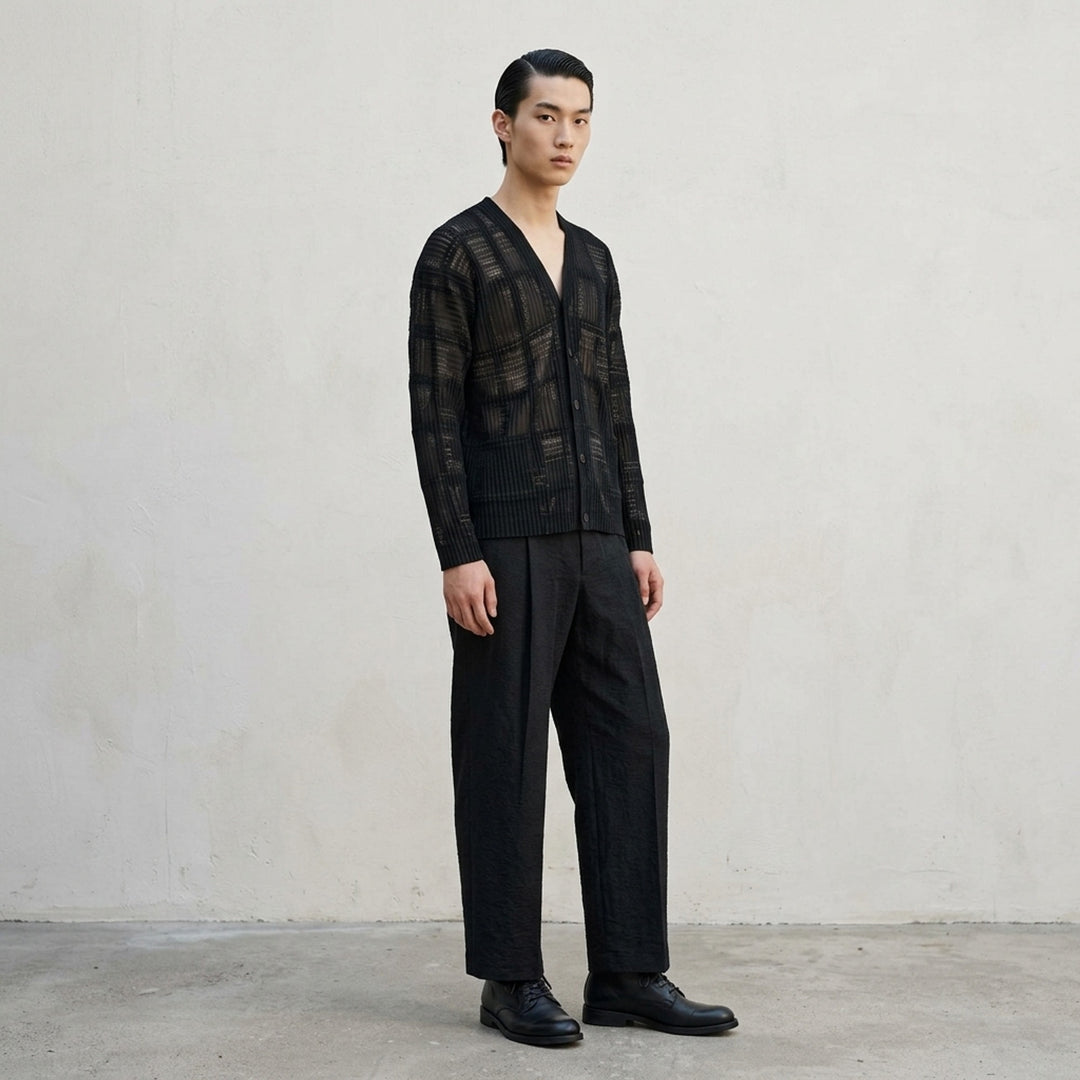 Homme Plissé Issey Miyake Opacity Woven Pants in black, flat lay showing wide-leg silhouette with front creases and elasticated drawstring waistband - lifestyle
