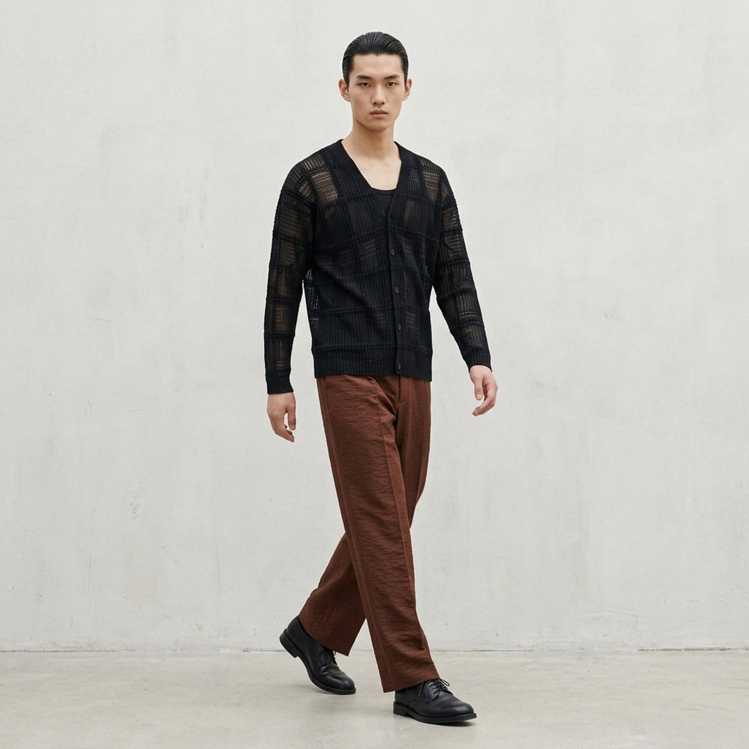 Homme Plissé Issey Miyake Opacity Woven Pants in black, flat lay showing wide-leg silhouette with front creases and elasticated drawstring waistband - lifestyle
