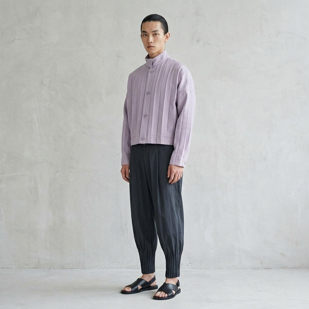 Homme Plissé Issey Miyake Edge Ensemble Pleated Blouson in deep forest green, featuring a stand collar, tonal button front, patch chest pockets, and micro-pleated fabric throughout - lifestyle