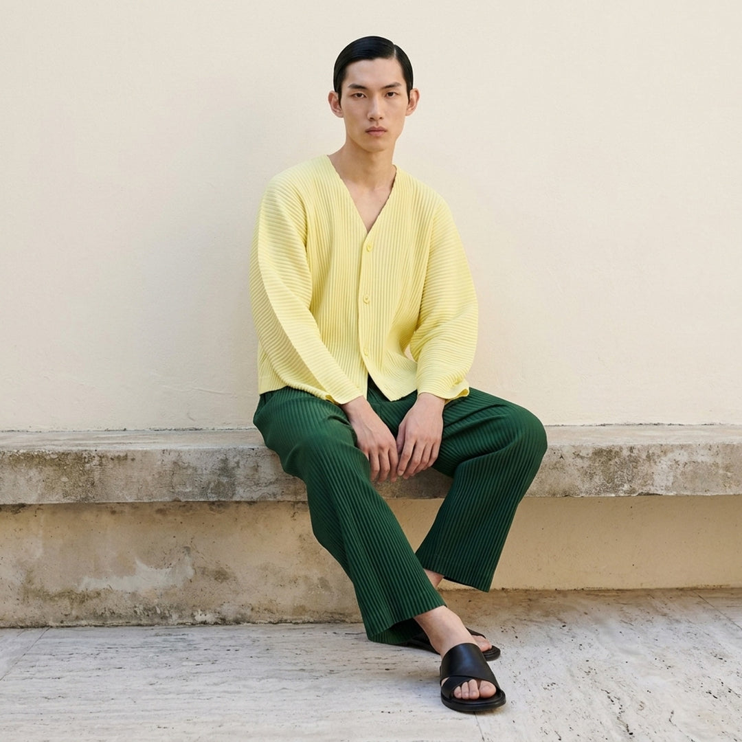 Homme Plissé Issey Miyake Slash Pleated Cardigan in olive green, featuring signature micro-pleating, V-neckline, and tonal button front closure - lifestyle